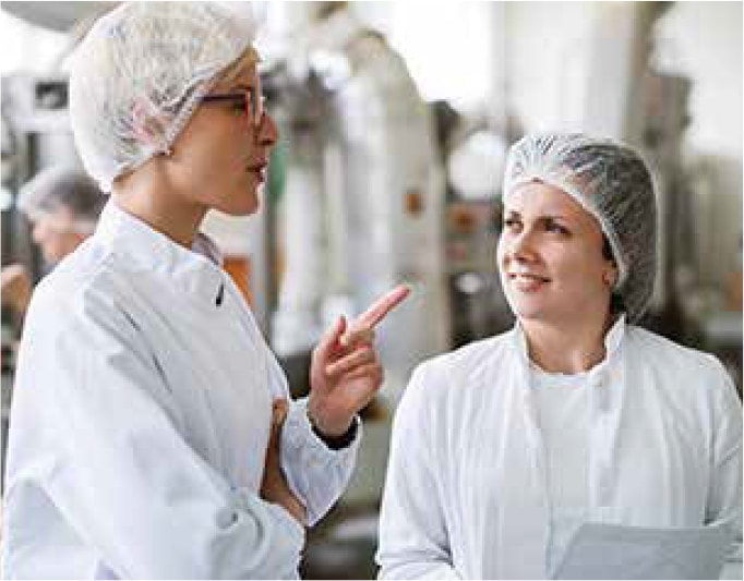 two workers at a meat facility